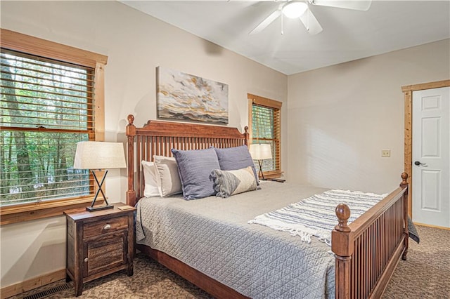 carpeted bedroom featuring visible vents and a ceiling fan