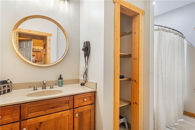 bathroom featuring vanity and curtained shower