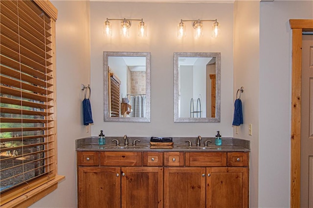 full bathroom with double vanity and a sink