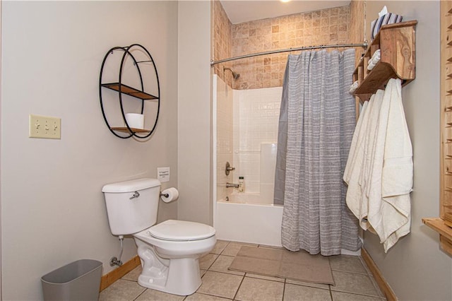 full bathroom with tile patterned floors, toilet, shower / bathtub combination with curtain, and baseboards