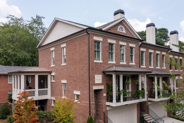 3734 Paige Way NE Unit 10, Atlanta, GA 30319 - view of front facade with brick siding, a chimney, a sunroom, and a garage