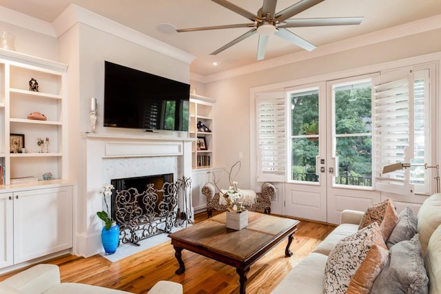 3734 Paige Way NE Unit 10, Atlanta, GA 30319 - living area featuring ceiling fan, light wood finished floors, ornamental molding, a fireplace with flush hearth, and built in features