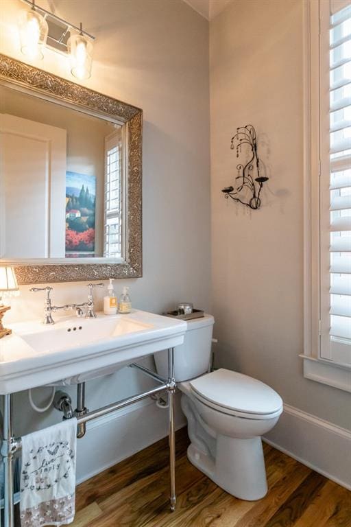 3734 Paige Way NE Unit 10, Atlanta, GA 30319 - half bathroom featuring wood finished floors, toilet, healthy amount of natural light, and baseboards