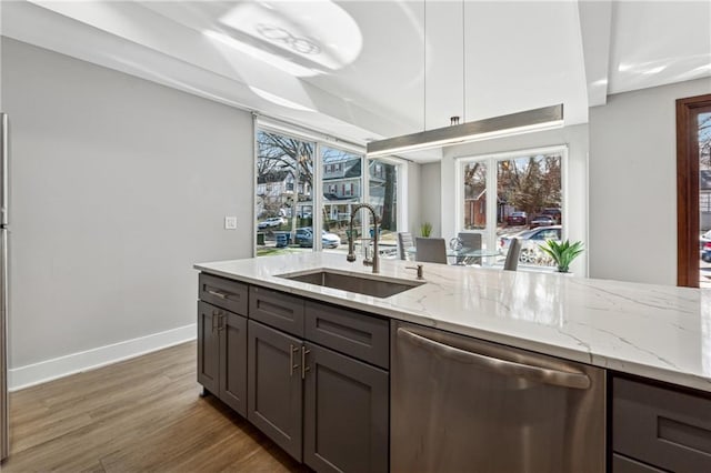 kitchen with dishwasher, sink, dark hardwood / wood-style flooring, light stone counters, and dark brown cabinets