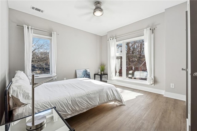 bedroom with hardwood / wood-style flooring and ceiling fan