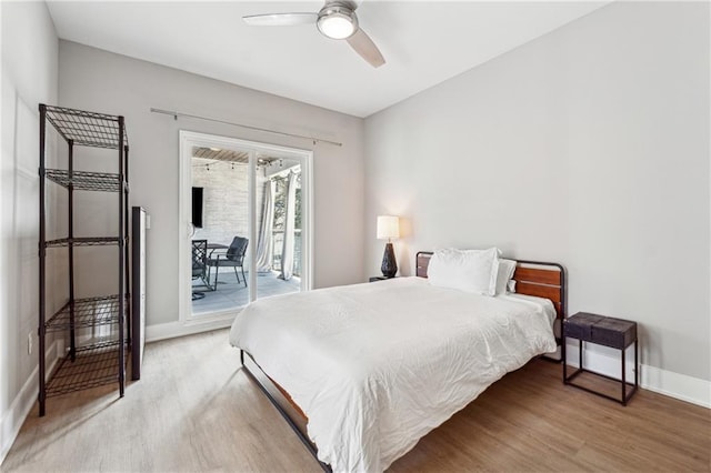 bedroom featuring hardwood / wood-style flooring, access to exterior, and ceiling fan