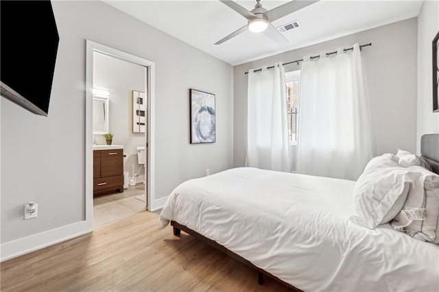 bedroom with light hardwood / wood-style floors, ceiling fan, and ensuite bathroom