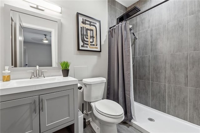 bathroom featuring vanity, toilet, and walk in shower