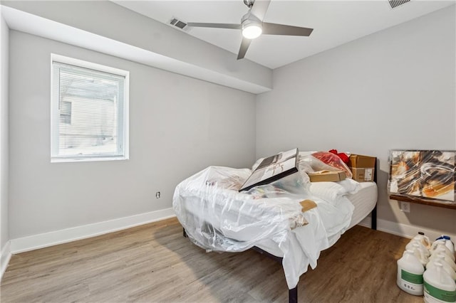 bedroom with hardwood / wood-style floors and ceiling fan