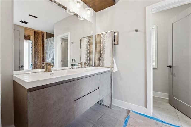 bathroom with tile patterned floors and vanity