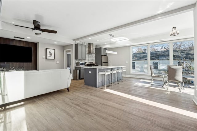 living room featuring ceiling fan and light wood-type flooring