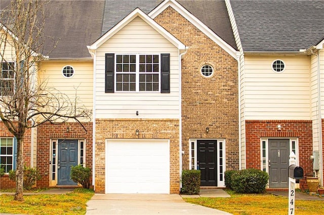 view of property featuring brick siding, concrete driveway, and an attached garage