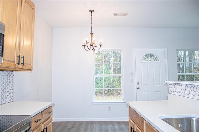 kitchen with light countertops, plenty of natural light, and a chandelier