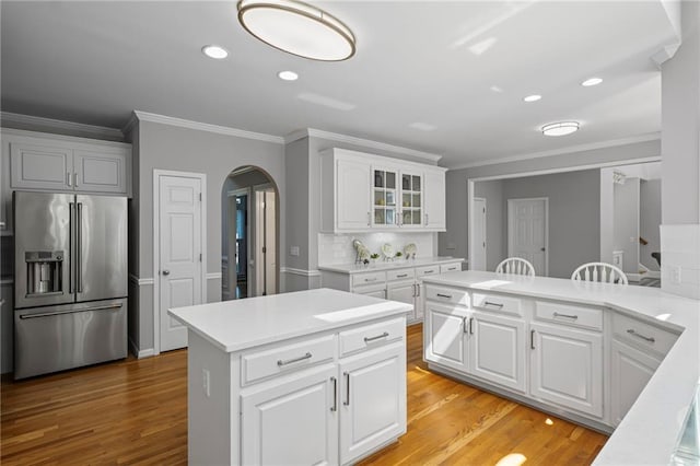 14270 Morning Mountain Way, Milton, GA 30004 - kitchen with high end fridge, arched walkways, ornamental molding, light countertops, and recessed lighting