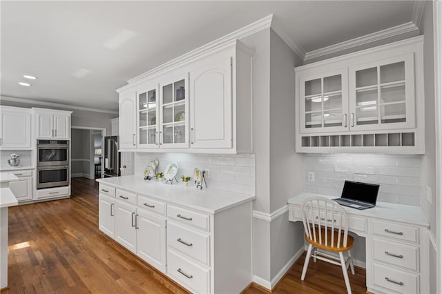 14270 Morning Mountain Way, Milton, GA 30004 - kitchen with stainless steel double oven, white cabinetry, crown molding, tasteful backsplash, and dark wood-style floors