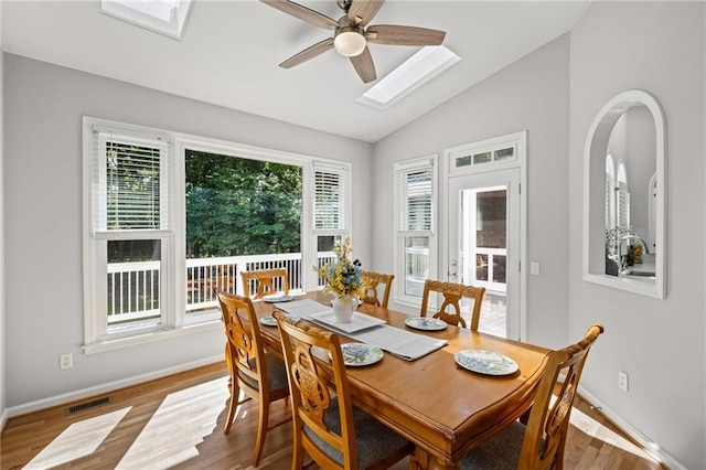 14270 Morning Mountain Way, Milton, GA 30004 - dining space featuring a skylight, vaulted ceiling, ceiling fan, and wood finished floors