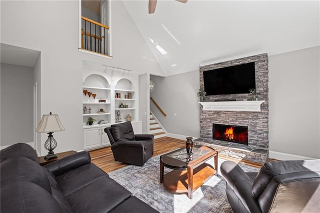 14270 Morning Mountain Way, Milton, GA 30004 - living area featuring light wood-style floors, stairs, ceiling fan, high vaulted ceiling, and a stone fireplace