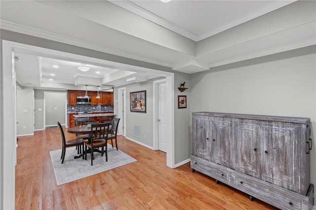 14270 Morning Mountain Way, Milton, GA 30004 - dining area featuring a tray ceiling, light wood-type flooring, and crown molding
