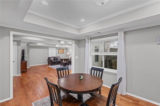 14270 Morning Mountain Way, Milton, GA 30004 - dining room featuring light wood-style floors, ornamental molding, and a raised ceiling
