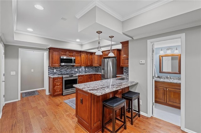 14270 Morning Mountain Way, Milton, GA 30004 - kitchen featuring stainless steel appliances, a peninsula, decorative backsplash, light wood-style floors, and a breakfast bar