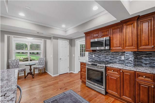 14270 Morning Mountain Way, Milton, GA 30004 - kitchen with appliances with stainless steel finishes, backsplash, crown molding, light wood-style floors, and light stone countertops