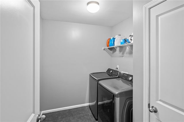 133 Worthing Ln, Fairburn, GA 30213 - laundry area with washing machine and clothes dryer and dark tile patterned flooring
