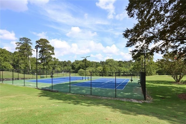 view of sport court featuring a lawn