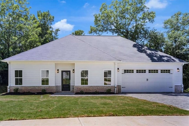 614 Glendale Rd, Scottdale, GA 30079 - view of front facade featuring a garage, a front lawn, driveway, and brick siding