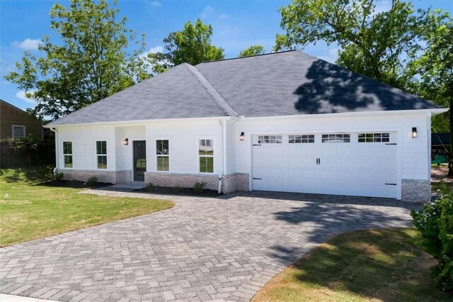 614 Glendale Rd, Scottdale, GA 30079 - view of front of property with an attached garage, brick siding, a front lawn, driveway, and roof with shingles