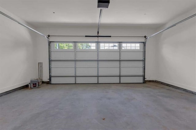 614 Glendale Rd, Scottdale, GA 30079 - garage with a garage door opener and baseboards
