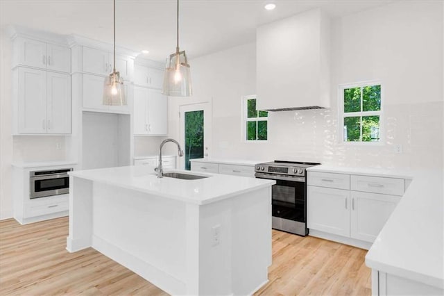 614 Glendale Rd, Scottdale, GA 30079 - kitchen with appliances with stainless steel finishes, a sink, light countertops, white cabinetry, and recessed lighting