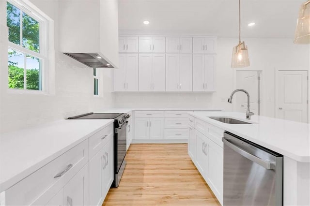 614 Glendale Rd, Scottdale, GA 30079 - kitchen with dishwasher, a sink, custom exhaust hood, black range with electric cooktop, and light countertops