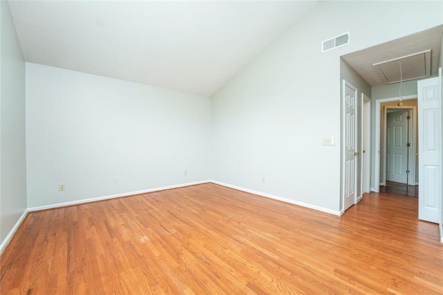 4400 Old Allgood Cir, Stone Mountain, GA 30083 - empty room with attic access, vaulted ceiling, light wood-style flooring, and baseboards