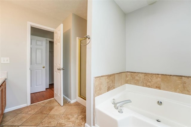 4400 Old Allgood Cir, Stone Mountain, GA 30083 - bathroom featuring a bath, vanity, baseboards, and a stall shower