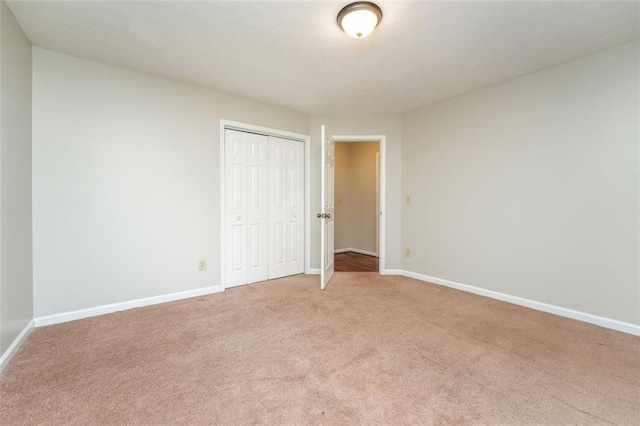 4400 Old Allgood Cir, Stone Mountain, GA 30083 - unfurnished bedroom with light colored carpet, baseboards, and a closet