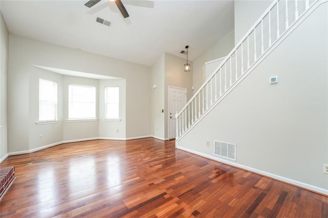 4400 Old Allgood Cir, Stone Mountain, GA 30083 - unfurnished living room with stairs, ceiling fan, wood finished floors, baseboards, and vaulted ceiling