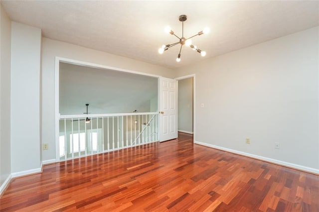 4400 Old Allgood Cir, Stone Mountain, GA 30083 - empty room with a chandelier, wood finished floors, and baseboards