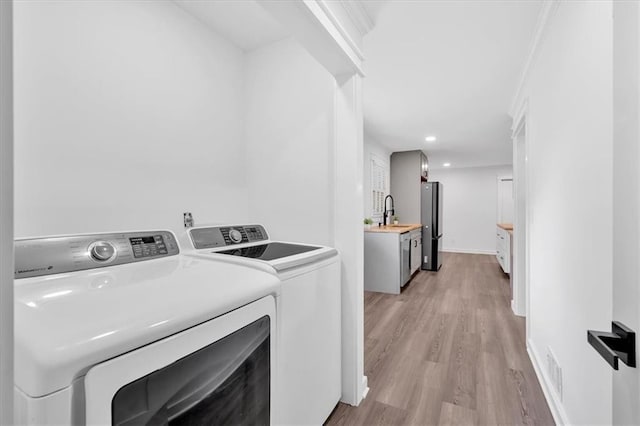 597 Rich Davis Rd, Hiram, GA 30141 - laundry area featuring washer and clothes dryer, light wood-type flooring, and recessed lighting
