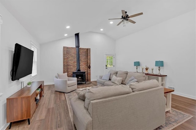 597 Rich Davis Rd, Hiram, GA 30141 - living room with a wood stove, a ceiling fan, recessed lighting, light wood-style flooring, and vaulted ceiling