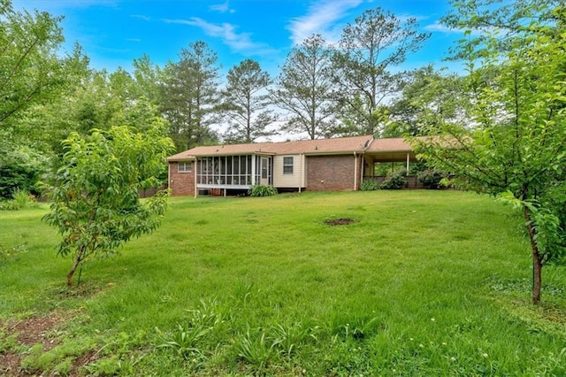 597 Rich Davis Rd, Hiram, GA 30141 - back of property with a sunroom, a yard, and brick siding