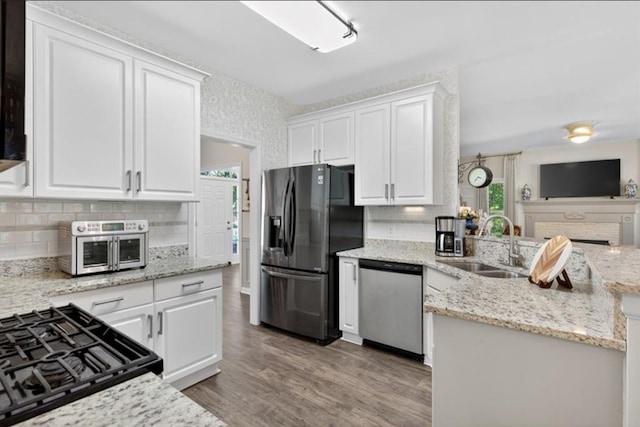 49 Inverness Ct, Hiram, GA 30141 - kitchen featuring stainless steel dishwasher, refrigerator with ice dispenser, white cabinetry, decorative backsplash, and range with gas stovetop