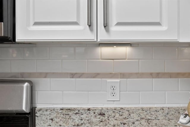 49 Inverness Ct, Hiram, GA 30141 - kitchen view of white cabinetry, decorative backsplash, and light stone countertops