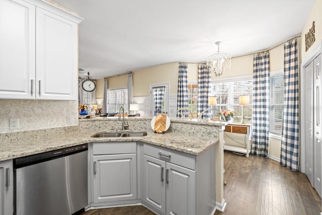 49 Inverness Ct, Hiram, GA 30141 - kitchen with dishwasher, a sink, a peninsula, a chandelier, and dark wood-style floors