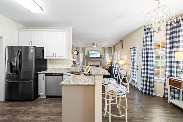 49 Inverness Ct, Hiram, GA 30141 - kitchen featuring fridge with ice dispenser, stainless steel dishwasher, a sink, a peninsula, and white cabinets