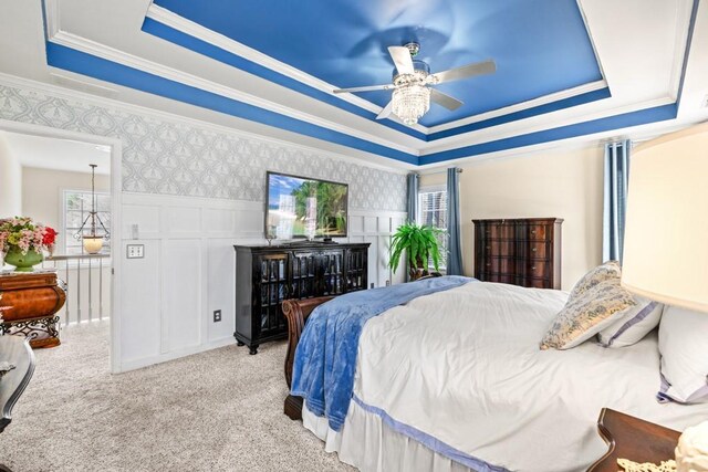 49 Inverness Ct, Hiram, GA 30141 - bedroom featuring a raised ceiling, multiple windows, crown molding, light carpet, and a decorative wall