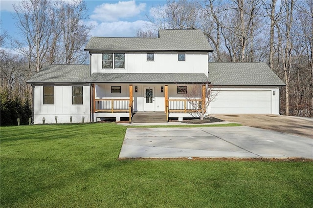 view of front of home featuring a garage, a front lawn, and covered porch