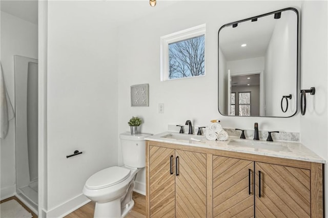 bathroom featuring vanity, hardwood / wood-style floors, and toilet