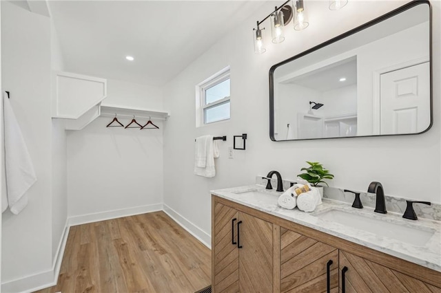 bathroom with hardwood / wood-style flooring and vanity