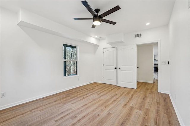 unfurnished room with ceiling fan and light hardwood / wood-style floors