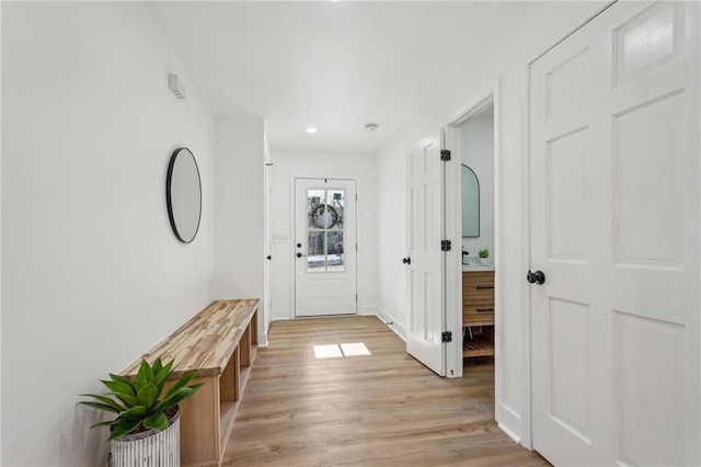 hallway with light hardwood / wood-style floors